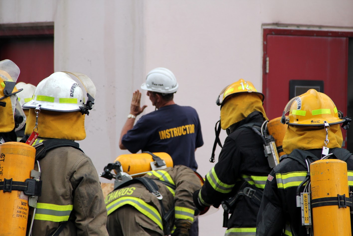 Instructor briefing firefighters wearing SCBA